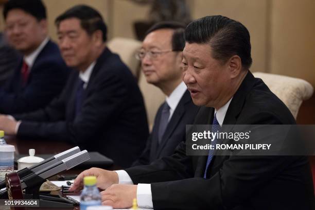Chinese President Xi Jinping speaks to Malaysian Prime Minister Mahathir Mohamad during their meeting at Diaoyutai State Guesthouse in Beijing on...