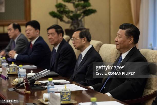 Chinese President Xi Jinping listens to Malaysian Prime Minister Mahathir Mohamad during their meeting at Diaoyutai State Guesthouse in Beijing on...