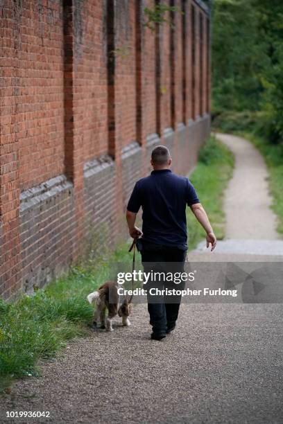 Drug search dog and ofiicer patrol the perimeter of Birmingham Prison in Winson Green, which has been taken over by the Ministry of Justice on August...