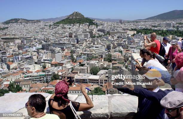 Tourists on Acropolis Hill on August 14, 2018 in Athens, Greece. Greece's final bailout officially ends after eight years of hugely unpopular and...