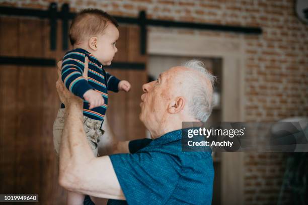 grandfather playing with his grandson - active baby boomer stock pictures, royalty-free photos & images