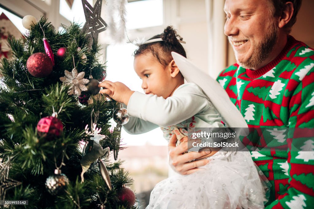 Decorating the Christmas Tree with her Father