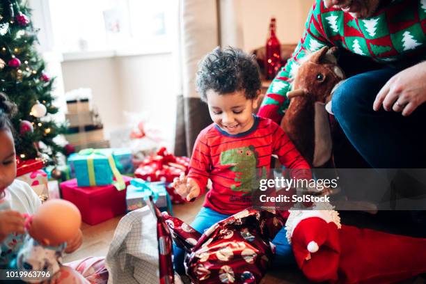 opening gifts with their father at christmas - stocking tops stock pictures, royalty-free photos & images