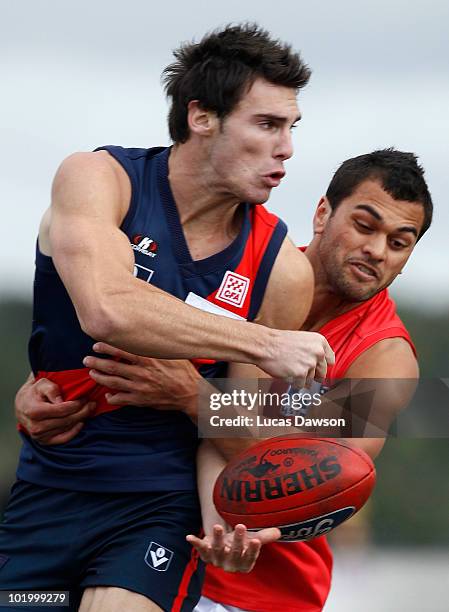 Karmichael Hunt of the Gold Coast tackles David Gourdis of the Tigers during the round nine VFL match between the Coburg Tigers and the Gold Coast at...