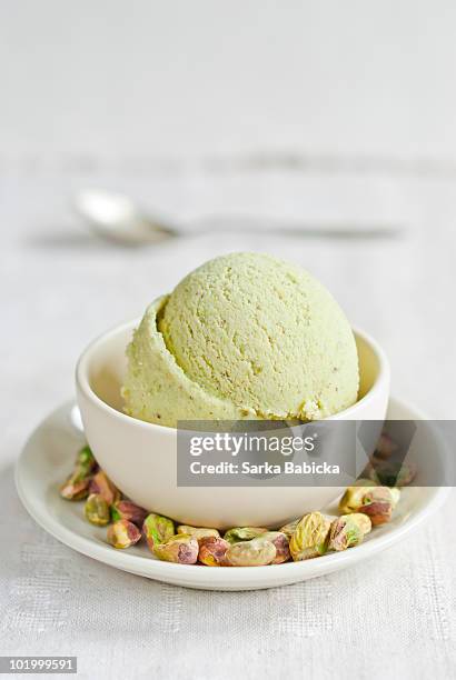 pistachio ice cream in white bowl - pistachio ice cream stock pictures, royalty-free photos & images