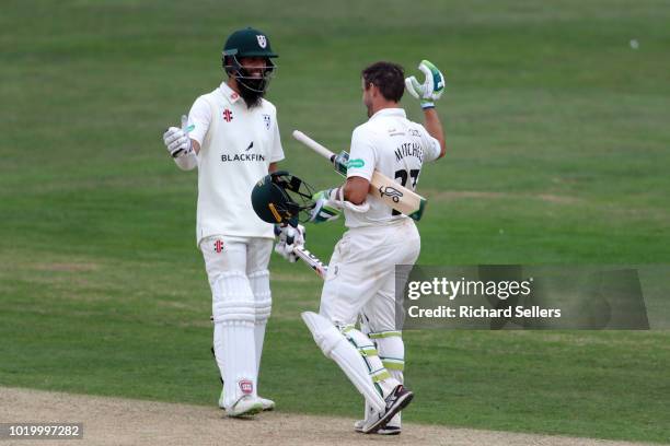 Worcestershire's Daryll Mitchell is congratulated by Worcestershire's Moeen Ali raises after his century during day two of the Specsavers...