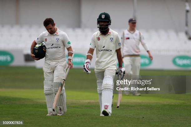 Worcestershire's Moeen Ali and Worcestershire's Daryll Mitchell walk off as rain falls during day two of the Specsavers Championship Division One...