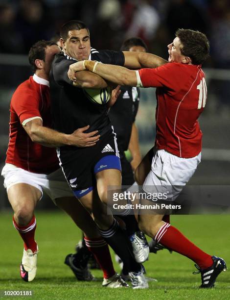 Dwayne Sweeney of New Zealand Maori fends off Colin Slade of the New Zealand Barbarians during the rugby union match between New Zealand Maori and...