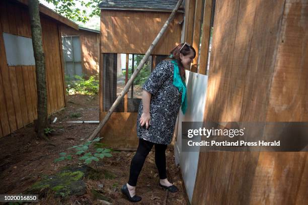 Kristen Lamb. Executive director at the Center for Wildlife, peaks in to a porcupine's cage at the Center for Wildlife on Thursday, August 16, 2018....