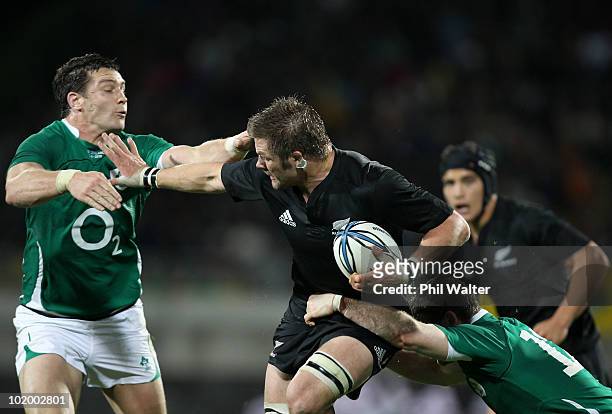 Richie McCaw of the All Blacks fends off the Irish defence during the International rugby test match between the New Zealand All Blacks and Ireland...