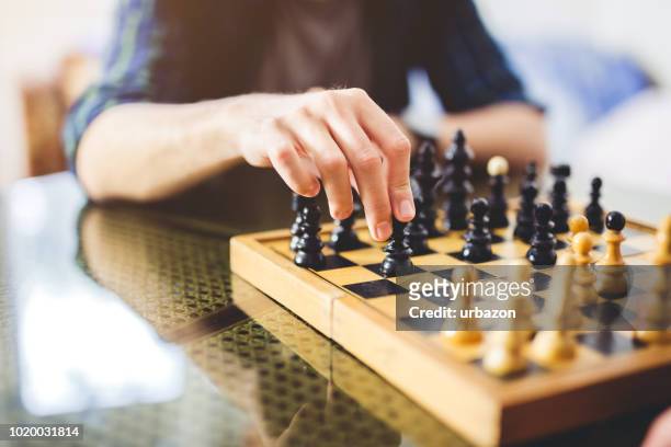 young man playing chess - bishop chess stock pictures, royalty-free photos & images