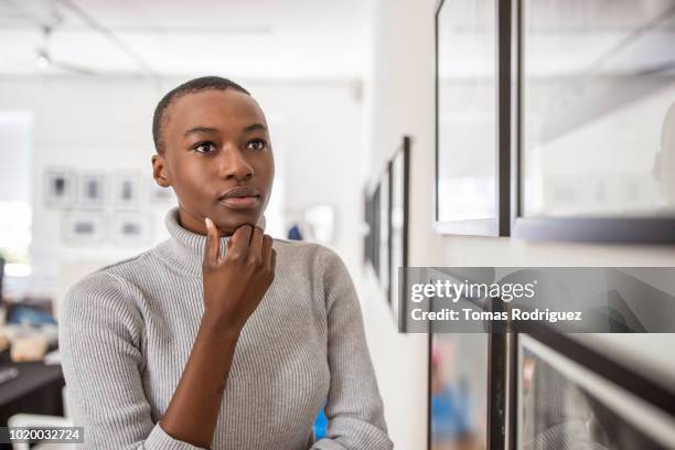 portrait of a young woman in an art gallery looking at pictures - curator stock pictures, royalty-free photos & images