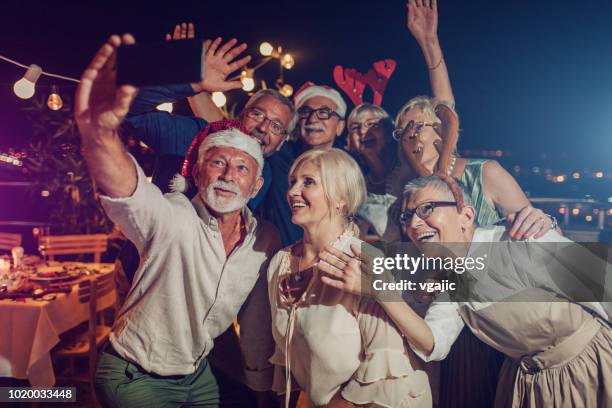 senior new year rooftop party - dinner christmas selfie stock pictures, royalty-free photos & images