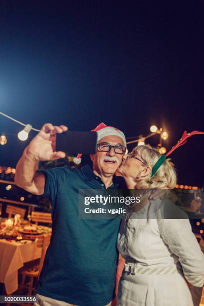 senior new year rooftop party - dinner christmas selfie stock pictures, royalty-free photos & images