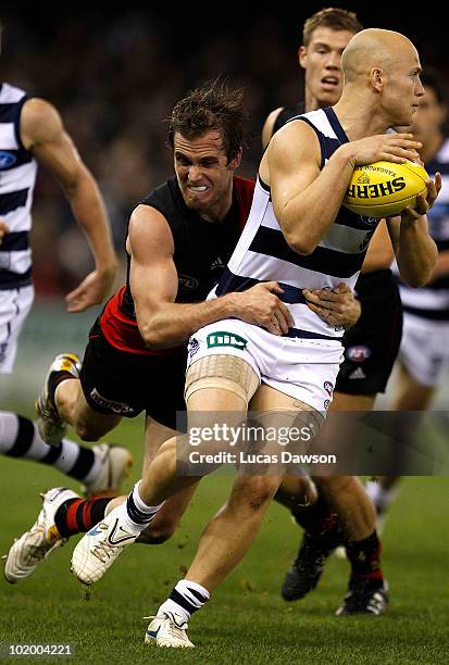 Andrew Welsh of the Bombers tackles Gary Ablett of the Cats during the round 12 AFL match between the Essendon Bombers and the Geelong Cats at Etihad...