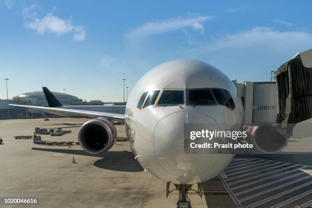 commercial airplane parking at the international airport waiting for boarding. - plane fuselage stock pictures, royalty-free photos & images