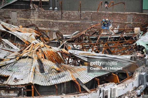 Workmen take down the roof on the O2 ABC music venue next to Glasgow School of Art's Mackintosh building where work to take down the damaged masonry...