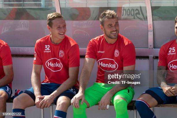 Robin Bormuth of Fortuna Duesseldorf and Goalkeeper Michael Rensing of Fortuna Duesseldorf laugh during the DFB Cup first round match between TuS RW...