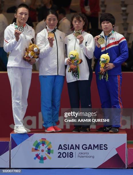 Silver medallist Kyrgyzstan's Aisuluu Tynybekova, gold medallist Mongolia's Orkhon Purevdorj, bronze medallistA Japan's Risako Kawai and North...