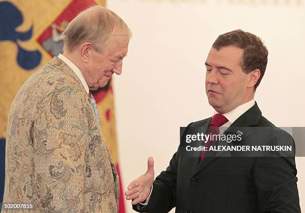 Russia's President Dmitry Medvedev approaches to shake hands with Russian poet Yevgeny Yevtushenko after presenting him the State Award during a...