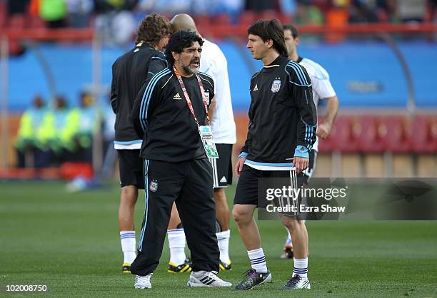 Diego Maradona head coach of Argentina conducts warm up exercises with striker Lionel Messi of Argentina ahead of the 2010 FIFA World Cup South...