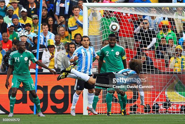 Gabriel Heinze of Argentina heads the ball into the top corner of the net to open the scoring during the 2010 FIFA World Cup South Africa Group B...