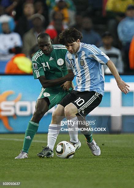 Nigeria's midfielder Sani Kaita fights for the ball with Argentina's striker Lionel Messi during their Group B first round 2010 World Cup football...