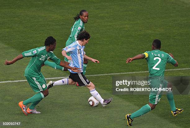 Argentina's striker Lionel Messi vies Nigeria's defender Joseph Yobo and Nigeria's midfielder Dickson Etuhu during their Group B first round 2010...