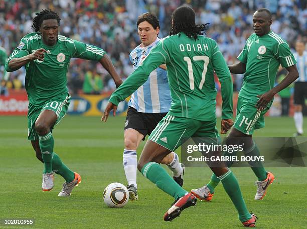 Argentina's striker Lionel Messi vies with Nigeria's midfielder Dickson Etuhu and Nigeria's defender Chidi Odiah and Nigeria's midfielder Sani Kaita...