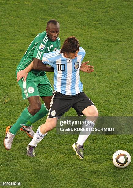 Argentina's striker Lionel Messi fights for the ball with Nigeria's midfielder Sani Kaita during their Group B first round 2010 World Cup football...