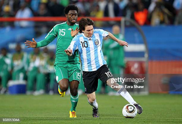 Lionel Messi of Argentina and Lukman Haruna of Nigeria battle for the ball during the 2010 FIFA World Cup South Africa Group B match between...