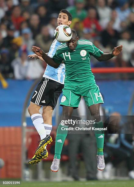 Angel Di Maria of Argentina and Sani Kaita of Nigeria jump for the ball during the 2010 FIFA World Cup South Africa Group B match between Argentina...