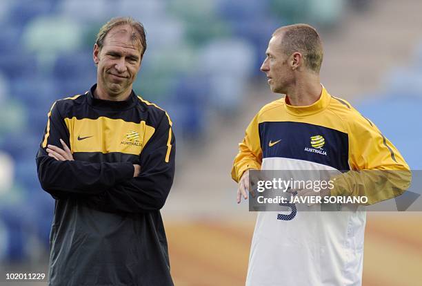 Australia's coach Pim Verbeek chats with defender Craig Moore during an official training session on the eve of their 2010 Football World Cup group D...