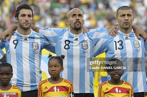 Argentina's striker Gonzalo Higuain, Argentina's midfielder Juan Sebastian Veron and Argentina's defender Walter Samuel pose before the Group B first...