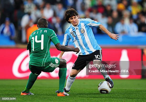 Lionel Messi of Argentina is challenged by Sani Kaita of Nigeria during the 2010 FIFA World Cup South Africa Group B match between Argentina and...