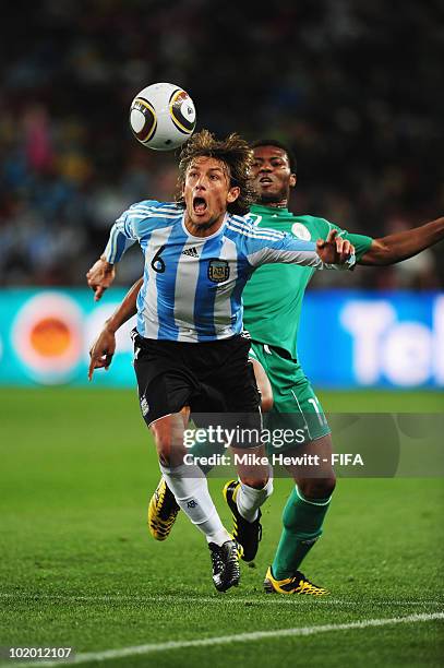 Gabriel Heinze of Argentina is challenged by Kalu Uche of Nigeria during the 2010 FIFA World Cup South Africa Group B match between Argentina and...