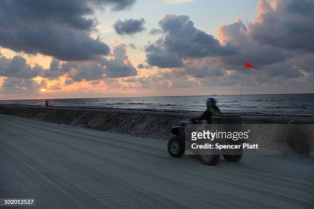 Workers hired by BP to help clean the beaches of oil work in a contaminated area on June 12, 2010 in Grand Isle, Louisiana. U.S. Government...