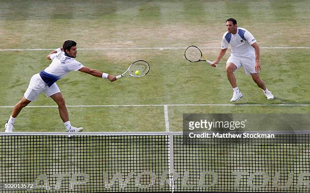 Novak Djokovic of Serbia and Jonathan Erlich in action during their doubles semi final match against Michael Llodra and Julien Benneteau of France on...