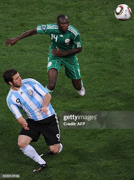Argentina's striker Gonzalo Higuain and Nigeria's midfielder Sani Kaita fight for the ball during the Group B first round 2010 World Cup football...