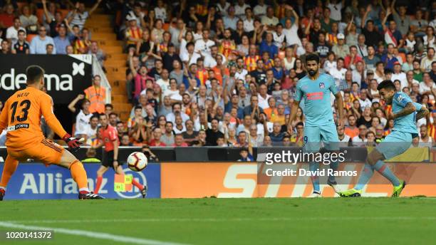 Angel Correa of Atletico Madrid scores his team's first goal past Norberto Murara Neto of Valencia during the La Liga match between Valencia CF and...