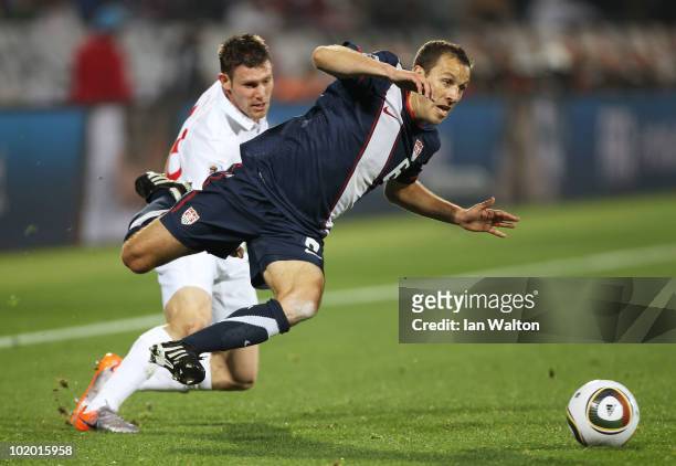 Steve Cherundolo of the United States is tackled by James Milner of England during the 2010 FIFA World Cup South Africa Group C match between England...