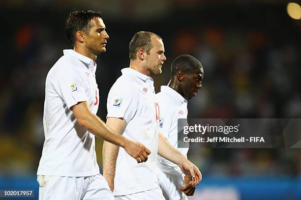 Steven Gerrard, Wayne Rooney and Shaun Wright Phillips of England leave the pitch after the 2010 FIFA World Cup South Africa Group C match between...