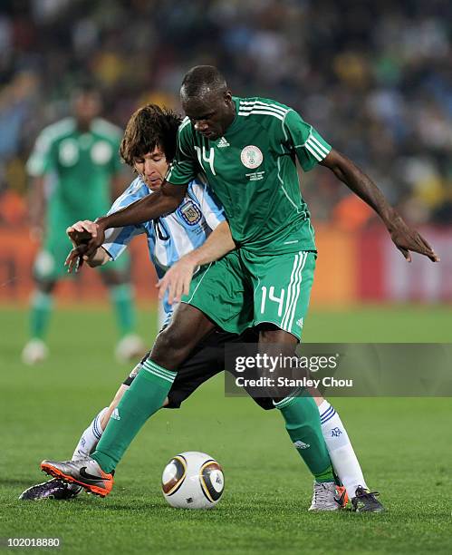 Lionel Messi of Argentina and Sani Kaita of Nigeria tussle during the 2010 FIFA World Cup South Africa Group B match between Argentina and Nigeria at...