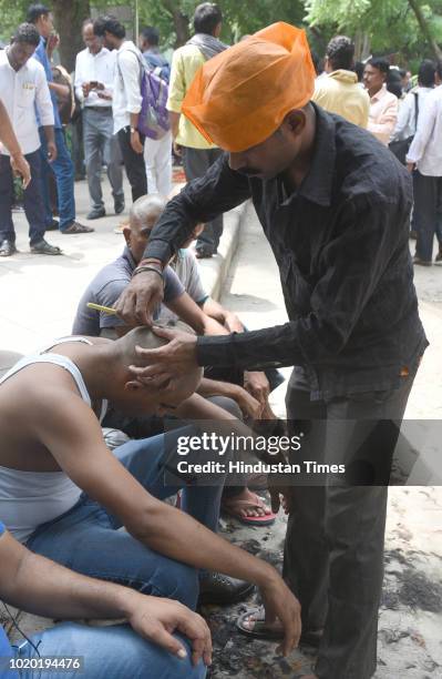 Workers of the Archaeological Survey of India led a protest by shouting slogans and shaving off their hair for their demands at Archaeological...