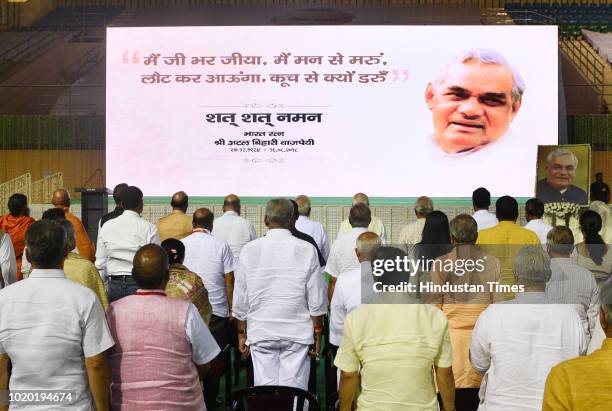 Leaders of all parties stand for a two minute silence during a prayer meeting to pay homage to late Atal Bihari Vajpayee at Indira Gandhi Indoor...