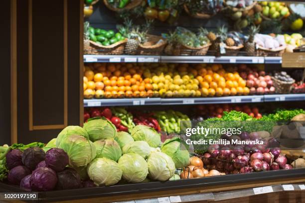 a fruit and vegetable stand at a local market - onion foto e immagini stock