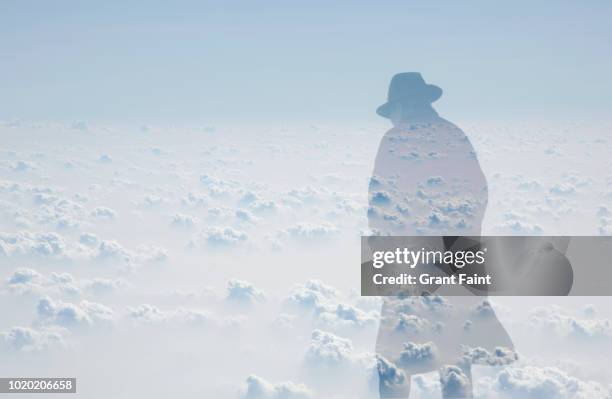 double exposure:shadow of old man in large coat walking. - cold war spy stock-fotos und bilder