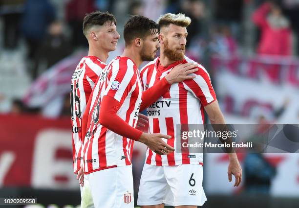 Fabian Noguera, Gaston Campi and Jonatan Schunke of Estudiantes celebrate after winning a match between Estudiantes and Boca Juniors as part of...