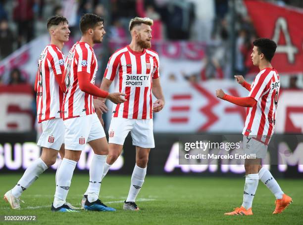 Fabian Noguera, Gaston Campi and Jonatan Schunke of Estudiantes celebrate after winning a match between Estudiantes and Boca Juniors as part of...