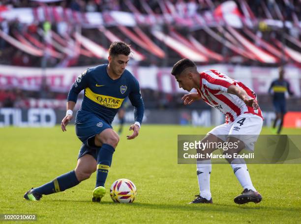 Cristian Pavon of Boca Juniors fights for the ball with Ivan Gomez of Estudiantes during a match between Estudiantes and Boca Juniors as part of...